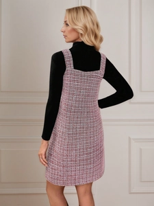 Side view of pink tweed pinafore dress styled with a black turtleneck sweater