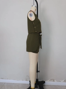 Detail view of olive green two-piece set featuring decorative side buttons and belted shorts