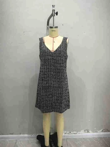 Detail showing the sleeveless V-neck tweed houndstooth dress on a tailor dummy