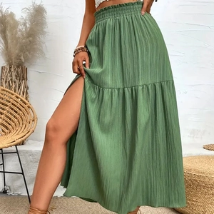 Detailed view of the elastic high waist with ruffled edges on a sage green maxi skirt