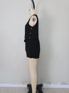 Detail showing side golden buttons and bow-tie waist belt on black sleeveless set