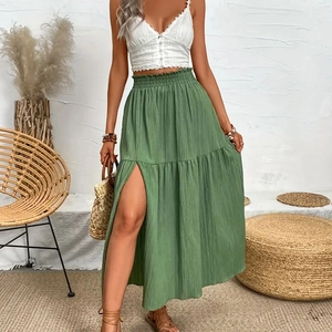 Close-up of green high-waisted tiered maxi skirt featuring a high side slit and soft texture