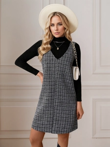 Houndstooth tweed V-neck sleeveless dress paired with black turtleneck sweater and hat