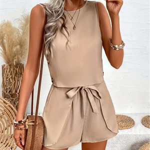 Detail of apricot sleeveless top with side buttons and matching tied bow shorts