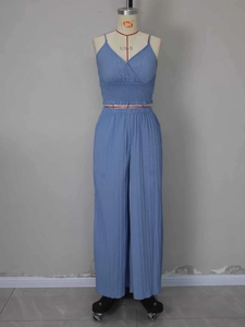 Detail of sky blue pleated V-neck camisole top and high waist wide leg pants set