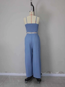 Detail of blue pleated smocked tank top and wide-leg trousers on a mannequin