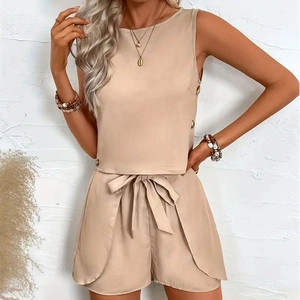 Detail view of apricot sleeveless top with buttons and high waist belted shorts set