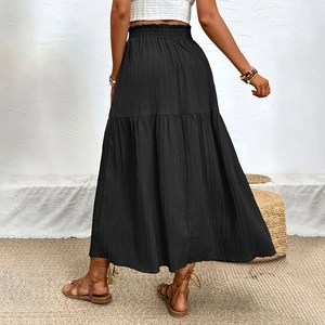 Rear view of a high-waisted black maxi skirt with elastic waist and tiered ruffle details