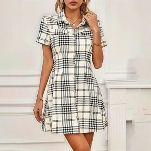 Detailed close-up of a houndstooth shirt dress with button-down waist and classic pattern