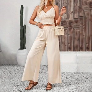 Detail of beige summer two-piece set with smocked crop top and high-waist wide-leg pants