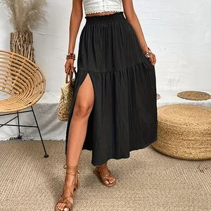 Detail of high waist tiered black maxi skirt featuring side split and ruffled texture