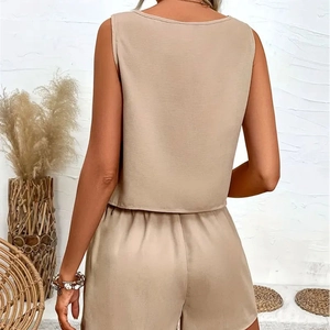 Detail of beige sleeveless crop top and shorts set with decorative ruffles on the back