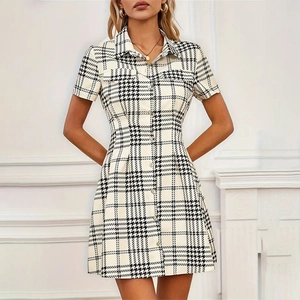 Close-up of black and white houndstooth shirt dress with lapel collar and buttons