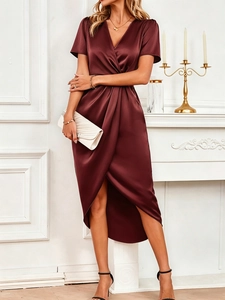 Detailed view of the elegant deep burgundy satin dress with V-neck and ruched waist details