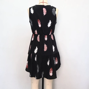 Detailed view of feather print sleeveless top with elastic waist and ruffled hem details