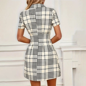 Back view of a houndstooth shirt dress featuring a slim A-line fit and cinched waistline
