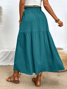 Deep teal tiered maxi skirt with elastic high waist and textured pleated fabric detail
