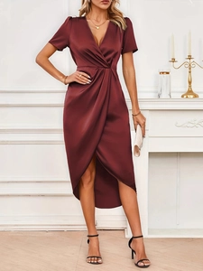 Detail of burgundy satin wrap dress featuring elegant V-neck and silky texture