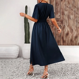 Detail of smocked elastic waist and ruffle short sleeves on a dark blue summer dress