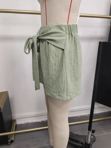 Women's light green high waist wide leg shorts with pleated texture and bow belt