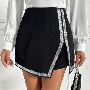 Detailed view of black high-waist mini skirt with asymmetric hem and silver sequin trim