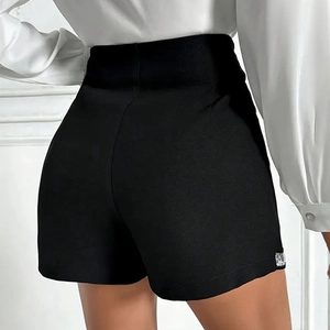 Detail of high-waisted black slim-fit shorts showing elegant side-back silhouette and fabric
