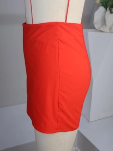 Detail shot of vibrant red bodycon skirt with button accents and premium stitching