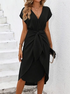 Detail of black wrap dress featuring a V-neckline and adjustable waist tie design