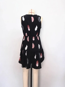 Sleeveless black tunic top with colorful feather print and ruffled hem for women