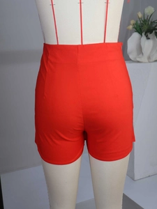 Rear view of high-waisted red shorts with structural darts and hidden side zipper closure
