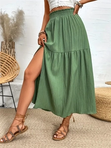 Elegant green high-waisted maxi skirt with side slit and ruffled elastic waist detail