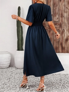 Navy blue short sleeve maxi dress with smocked waist and flutter sleeves from behind