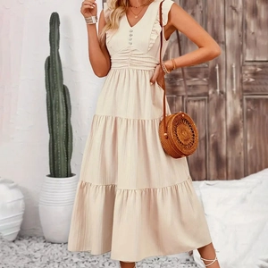 Detail of ruffle v-neckline and buttons on beige bohemian tiered long sleeveless dress