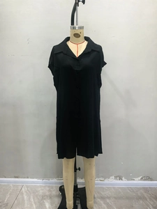 Detail view of black short-sleeved shirt dress featuring lapel collar and button-down front