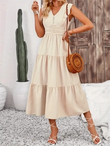 Elegant beige sleeveless tiered maxi dress with V-neckline and ruffle shoulder details