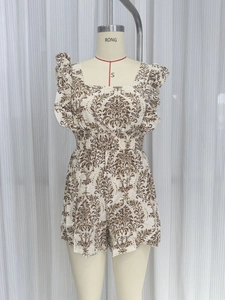 Detail view of ethnic floral print romper with square neck and smocked elastic waist