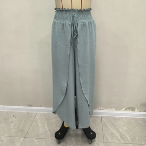 Detail of high waist wide leg pants with pleated texture and adjustable drawstring
