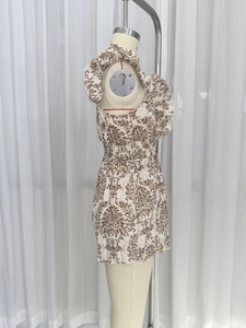 Detailed side view of ethnic floral print sleeveless romper with elastic smocked waist detail