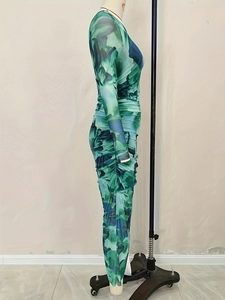 Detail of ruched green abstract print long sleeve slim fit maxi dress with side texture