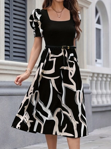 Detail of puffed sleeves with abstract prints and a square neckline on a knit dress