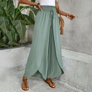 Detail of smocked elastic waistband with drawstring on sage green wide leg pants