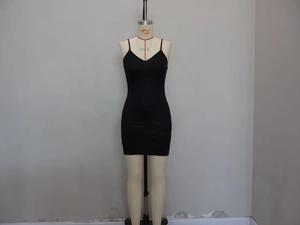 Detail of slim fit black slip dress with V-neckline and elastic bodycon fabric texture