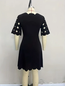 Elegant black short sleeve dress with scalloped edges and geometric hollow cutouts
