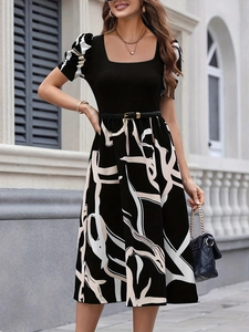 Detail of the elegant square neck top and abstract print A-line skirt with belt