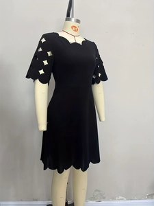Detail showing wavy ruffle neckline and circular hollow out sleeve design of black dress