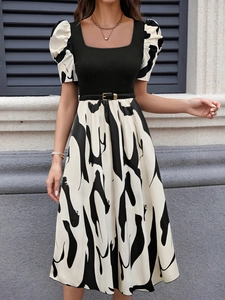 Detailed view of puff sleeves with abstract print and square neckline on a knit dress