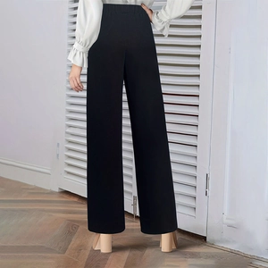 Rear view of high waisted black wide leg trousers with elegant drape for women