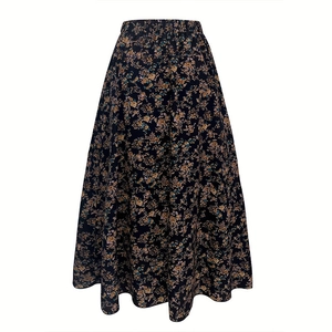 Detail view of the elastic high waist and floral pattern on this A-line pleated skirt