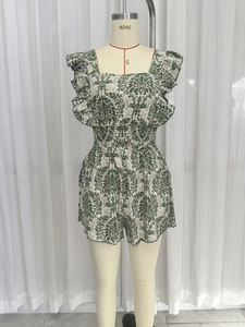 Detail view of ethnic print romper featuring square neck and elastic smocked waist