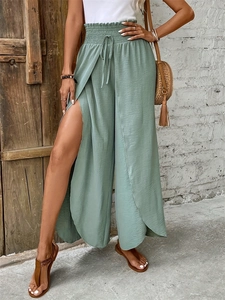 Detail of sage green wide-leg pants with high elastic waist and side slit design